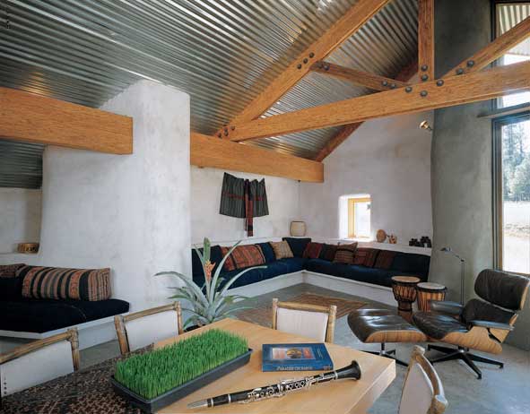 Here, sink-into-sofa pillows are wrapped in Ikat sarongs from Indonesia, while a handspun, hand-dyed Guatamalan fabric punctuates the wall with pattern and texture.